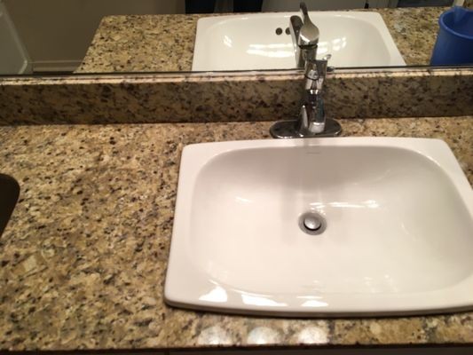 Polished bathroom sink and faucet after deep clean